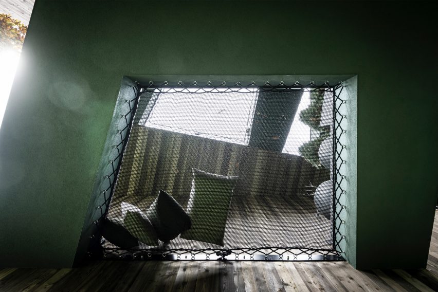 A netted seating area in the Floris hotel extension by NOA