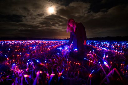 Girl walking through Grow installation by Studio Roosegaarde