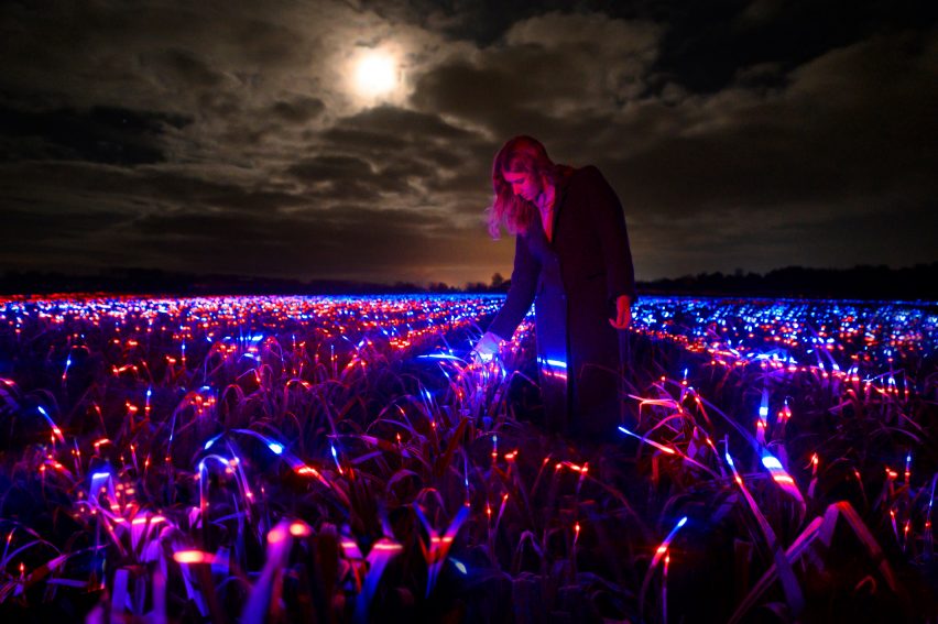 Girl walking through Grow installation by Studio Roosegaarde