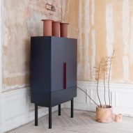 A navy wooden cupboard in a Japandi interior