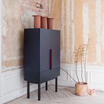 A navy wooden cupboard in a Japandi interior
