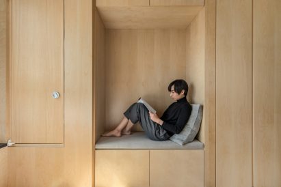 A reading nook inside a LIFE micro-apartment by Ian Lee