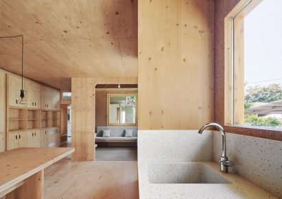 Stone sink and timber table inside the open plan kitchen diner