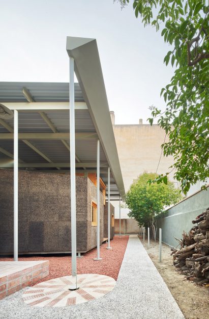 Red and grey gravel create paths around the structures