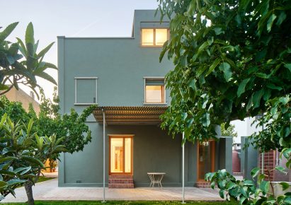 Frontal view of the green-painted original home