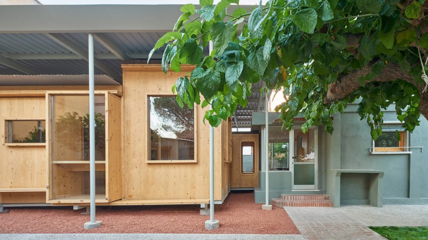 Cross-laminated timber new build next to original brick home