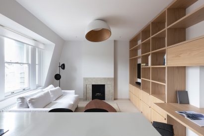 Living room with built-in timber furniture in a London apartment
