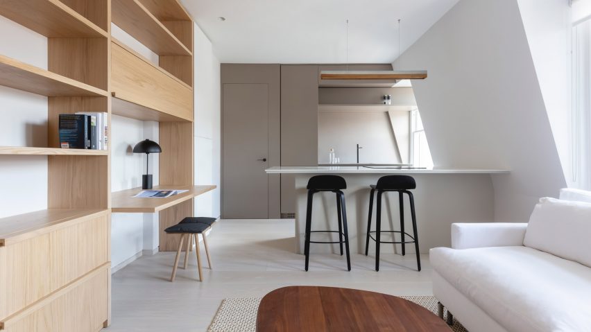 Kitchen and built-in shelves in pied-à-terre interior by Mwai