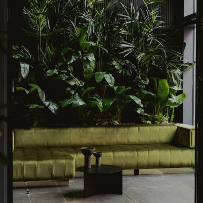Green walls and sofa in the Urban HQ office by Kingston Lafferty Design