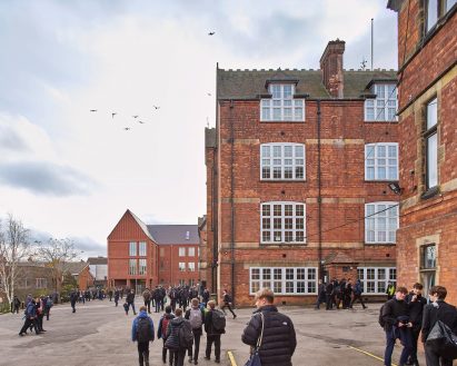 Gothic-revival original building next to new structure