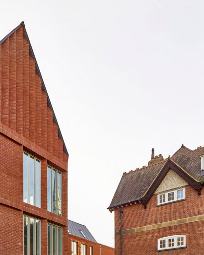 Windows are dotted across the facade amongst red brick 