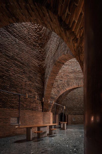 A restaurant with arched red-brick interiors