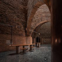 A restaurant with arched red-brick interiors
