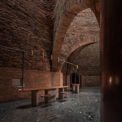 A restaurant with arched red-brick interiors