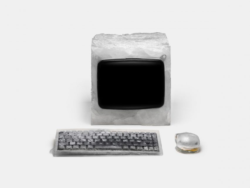 A desktop computer made out of ice with an ice keyboard and an ice mouse