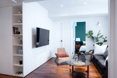 Wooden floors in white flat with green accent wall