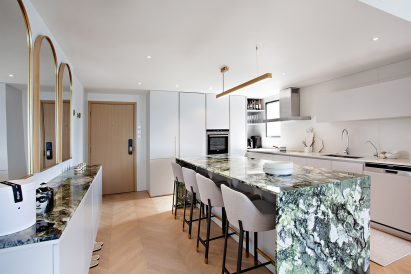 Green marble kitchen table in white kitchen