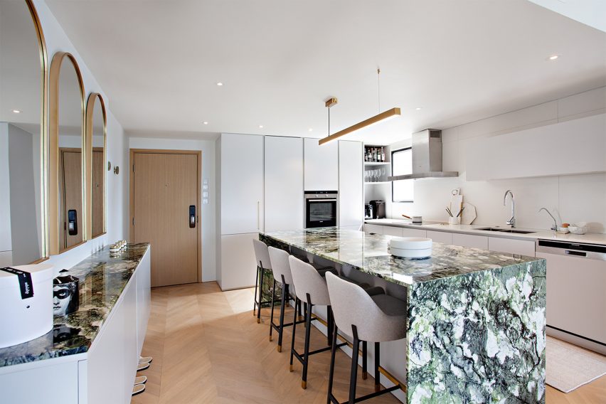 Green marble kitchen island in white kitchen