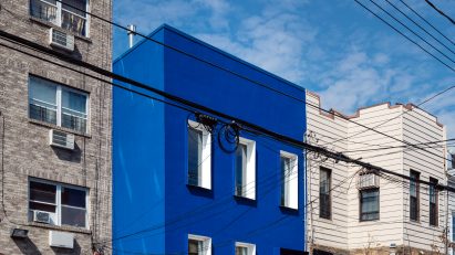 The Blue Building contrasts with surrounding buildings