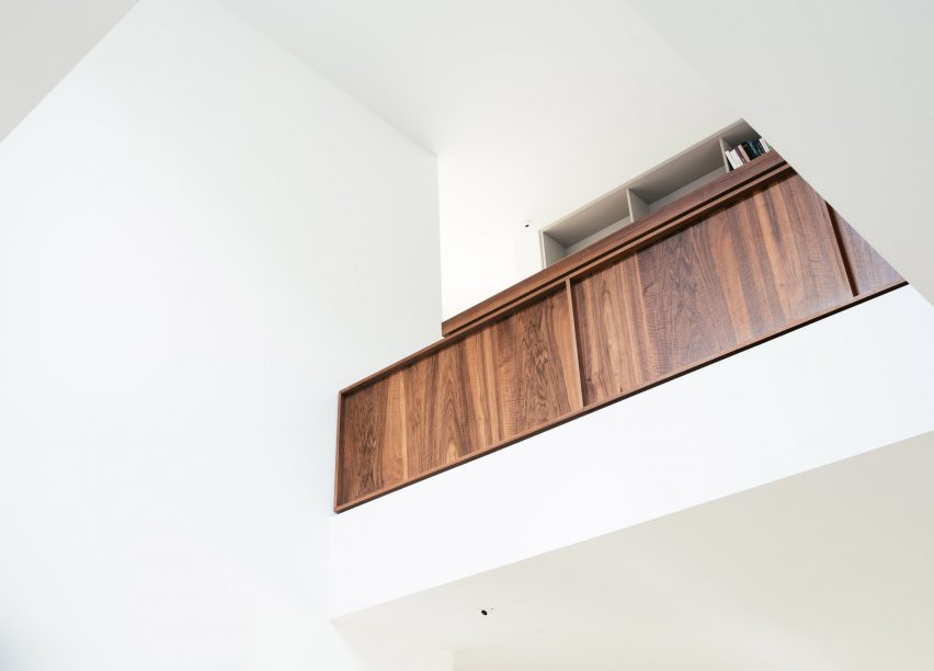 A walnut balustrade overlooks the living space