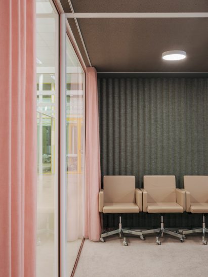 Pink curtains are paired with muted green walls