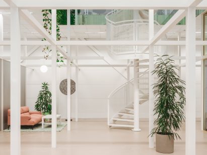 White perforated spiral staircase complements the white framework
