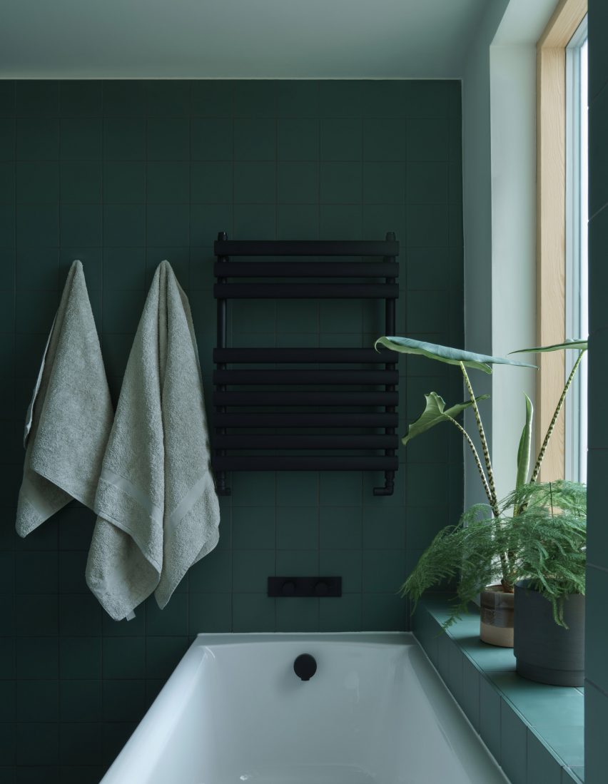A green bathroom in a house renovation in London by DeDraft
