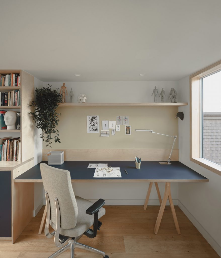 A workspace in the attic of a house in London by DeDraft
