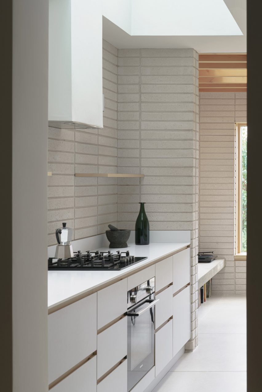 A white kitchen in a house extension in London by DeDraft