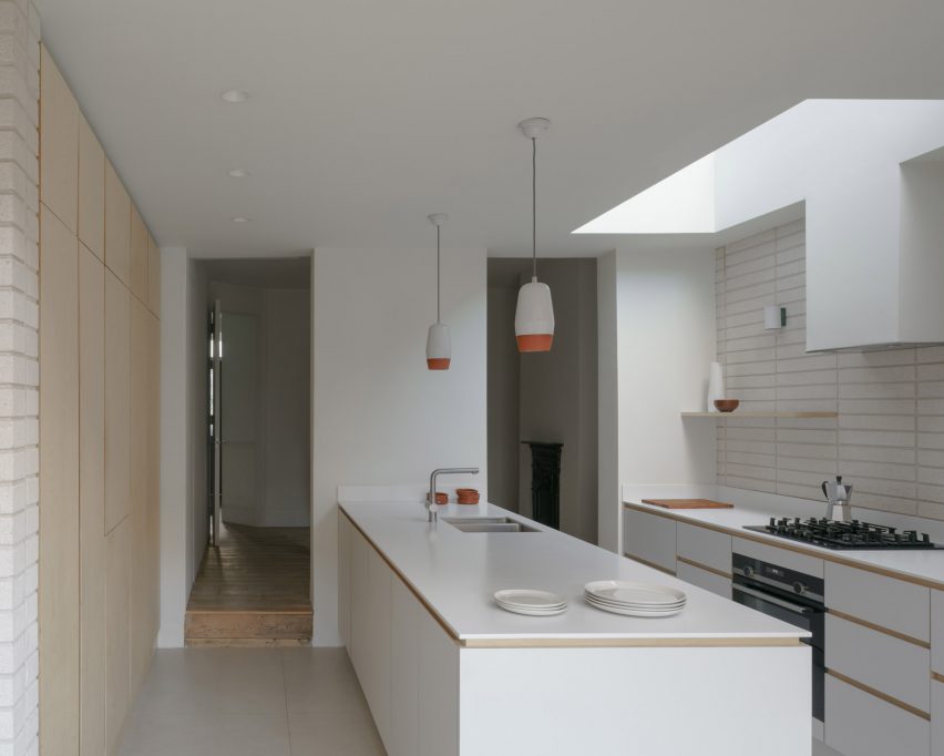 A white kitchen in a house extension in London by DeDraft