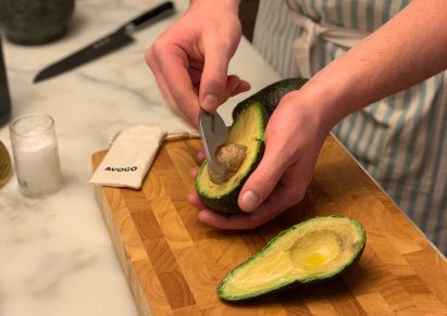 Avogo travel-sized avocado cutter in use
