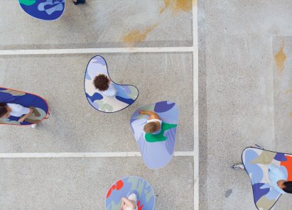 Aerial view of people wearing distance keepers from the Bounding Spaces collection
