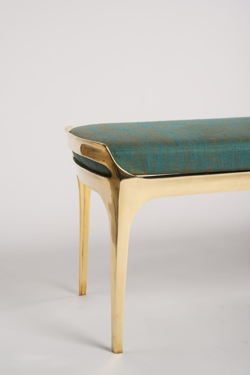 End of Bruda bench by Elan Atelier showing its gleaming gold finish
