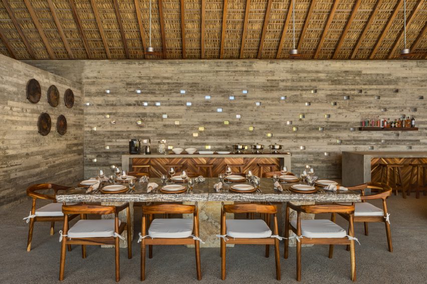 A large table in the shady dining area