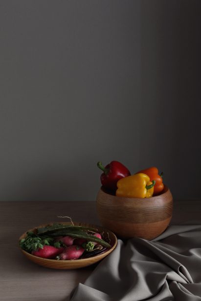 Wooden serving bowls with fruit in them