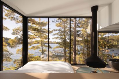 Bedroom with fireplace and bath in Candian lake house