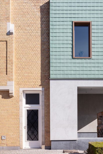 Wood windows are dotted between the cladding