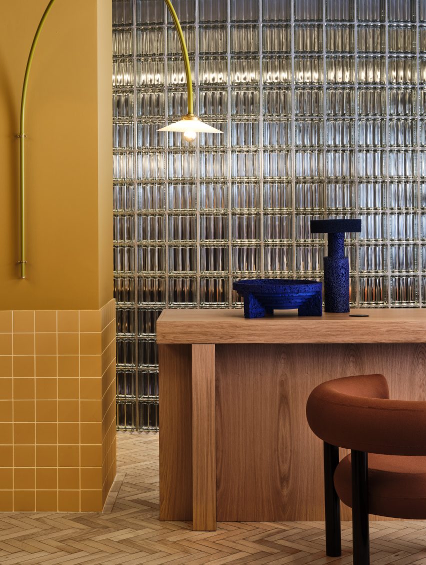 Glass block wall and yellow ceramic tiles in office