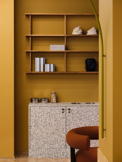 Yellow room with terrazzo furniture in Douglas House