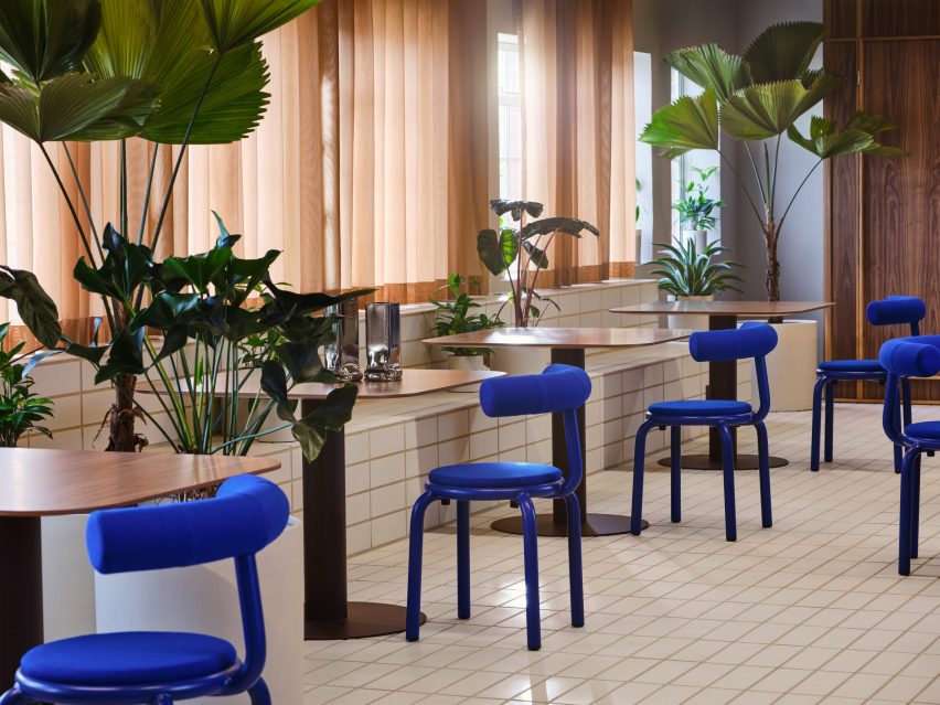 Tiled floor with klein blue chairs and plants