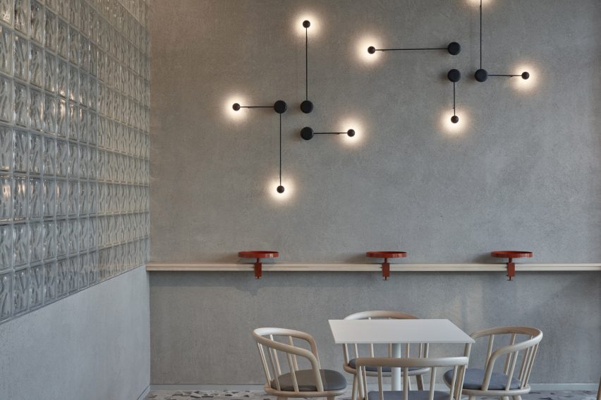 Concrete-style wall with metal lamps