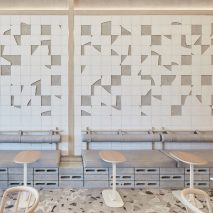 White ceramic mosaic and grey terrazzo floor in cafe