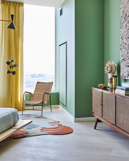 Bright green walls in bedroom with yellow curtain