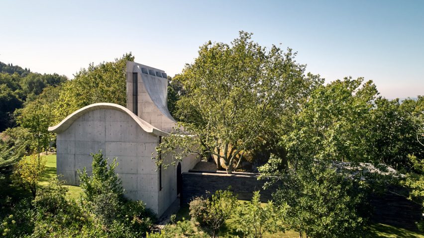 A concrete chapel hidden within amongst trees