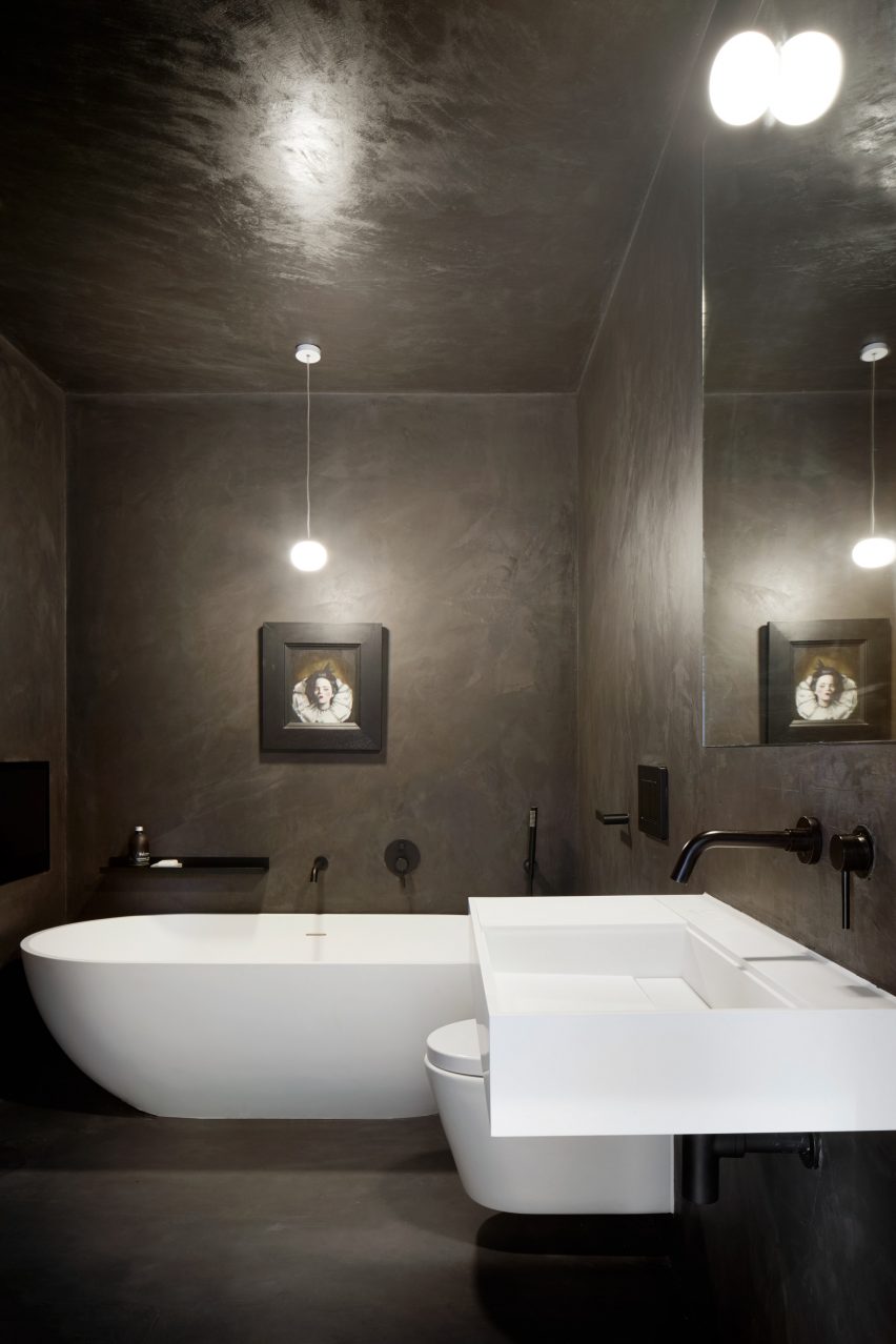 A dark bathroom within the House in Bearsden by McGinlay Bell