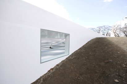 A white plaza embedded in a landscape