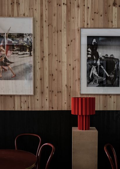 Red pleated lamp and black and white prints by Roland Hjort