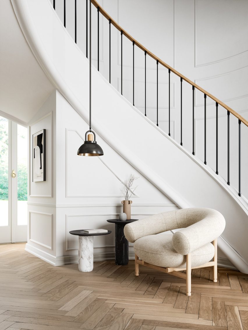 The lounge chair sits by a staircase