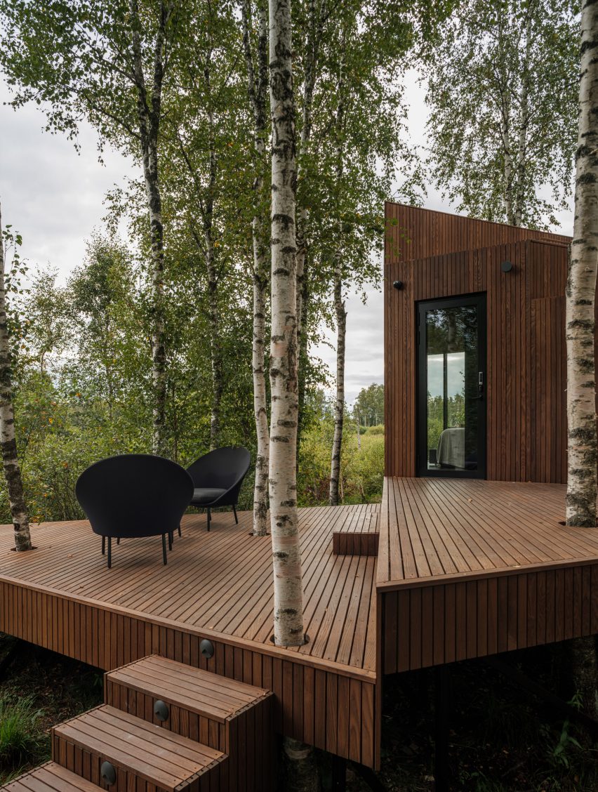 Dark wood decking outside a small cabin