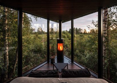 The glass-walled interior of a wooden cabin